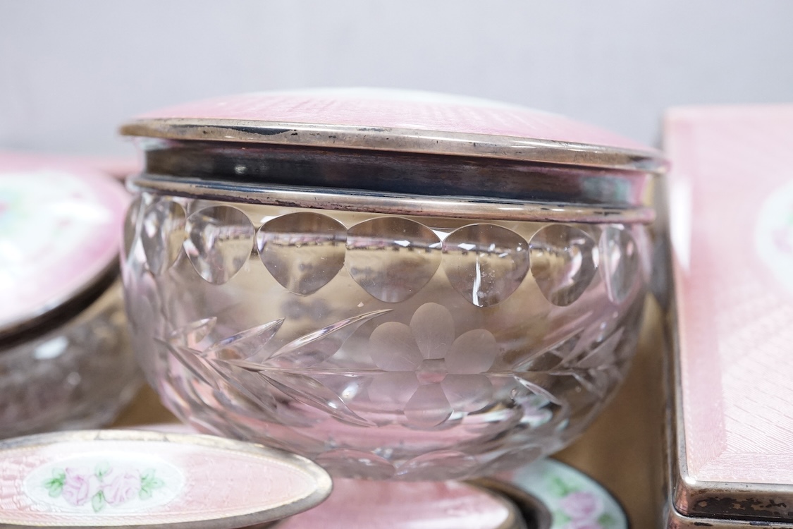 An early century North American sterling and enamel dressing table set by Theodore W. Foster & Bro, comprising fourteen items including hand mirror, 29.1cm, brushes, trinket box, nail buffer on stand, toilet jars, powder